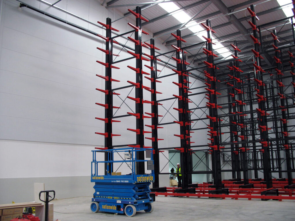 Stakapals in-house SEIRS team have come to a customers' site to install cantilever racking. With the column assembled, it is now being holstered up through the use of a heavy duty vehicle.